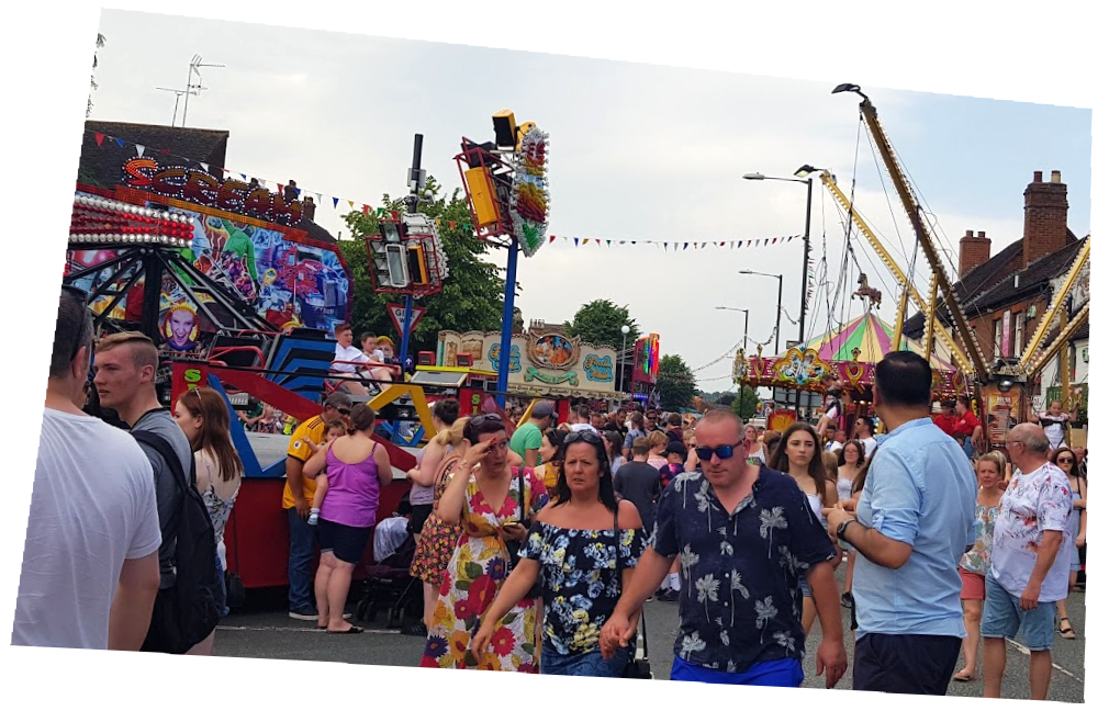 a photo of crowds at a funfair